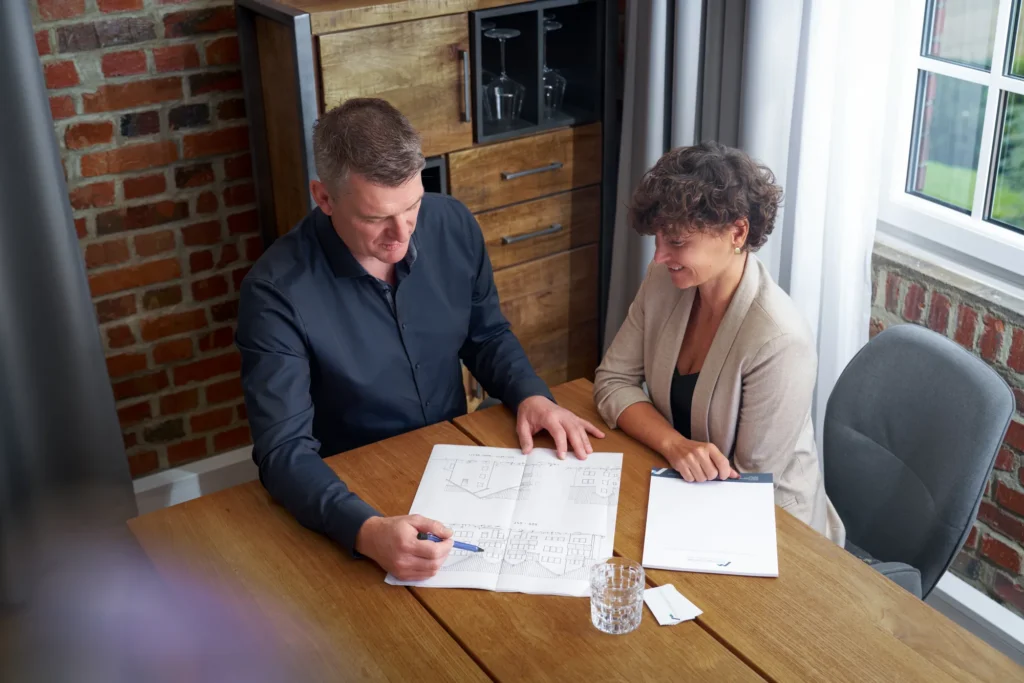 Unterlagen zum Immobilienverkauf werden im Büro besprochen